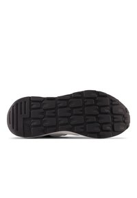 Black rubber sneaker sole with multi-directional tread pattern, featuring a grey cushioned upper and subtle branding detail.