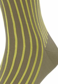 Calze verde oliva con sottili strisce verticali gialle. Il materiale sembra morbido ed elasticizzato con una texture liscia.