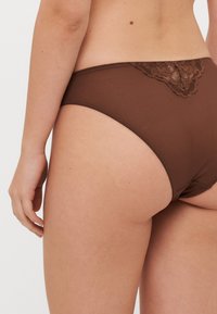 Mutande hipster in cotone marrone con bordo in pizzo sul retro. Tessuto morbido con un design a copertura totale, che offre una vestibilità confortevole.