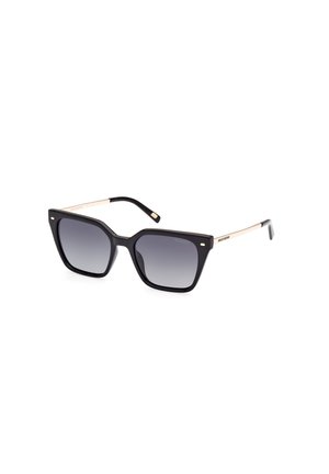 Black oversized sunglasses with gradient gray lenses. Smooth plastic frame, gold metal accents, angular shape, and wide temples.