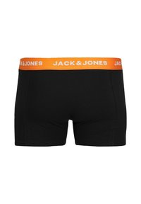 Black boxer shorts with an orange elastic waistband featuring "JACK & JONES" text. Smooth fabric, fitted design, and mid-thigh length.