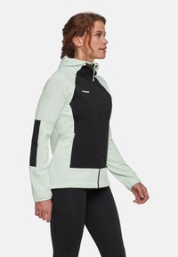Lichtgroene en zwarte fleece jas met een ritssluiting aan de voorkant, capuchon en zijzakken. Heeft contrasterende panels en een gestructureerde stof.