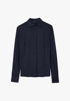 Marineblaue Bluse mit langen Ärmeln und spitzem Kragen, vorderem Knopfverschluss und Brusttaschen. Glattes Material mit matter Oberfläche.