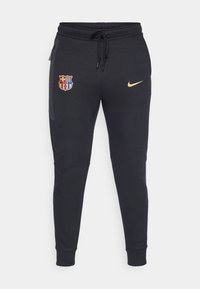 Zwarte sportieve joggers van zacht materiaal met een drawstring tailleband, taps toelopende pijpen, zijzakken met rits en borduurwetten in goud en rood.