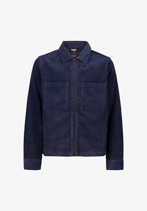 Chaqueta de pana de color azul marino con cremallera frontal, dos bolsillos en el pecho y un cuello clásico. Tejido texturizado con patrón acanalado.