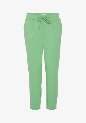 Pantaloni della tuta verdi realizzati in tessuto morbido, con vita regolabile tramite coulisse, due tasche frontali e design delle gambe affusolate.