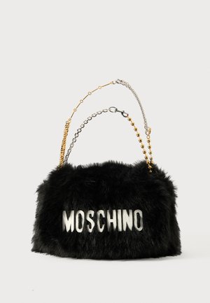 Black faux fur handbag with gold and silver chain straps. Features "MOSCHINO" logo in white on the front. Soft texture and rectangular shape.