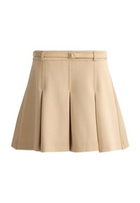 Mini-jupe plissée beige avec une ceinture ajustée et une ceinture assortie, en tissu texturé, présentée sur fond blanc.