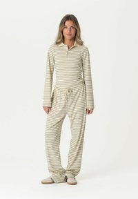Striped loungewear set featuring a long-sleeve top with a collar and three buttons, paired with elastic-waist pants, in cream and olive green.
