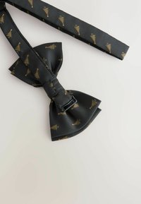 Black bow tie with gold tree pattern, made of smooth fabric. Features a buckle for adjustment and neatly tied bow shape.