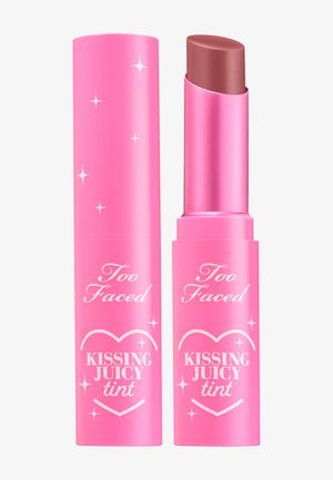 Lip tint in pink tube with a rounded tip. Features silver accents and text: "Too Faced" and "KISSING JUICY tint." Smooth texture.