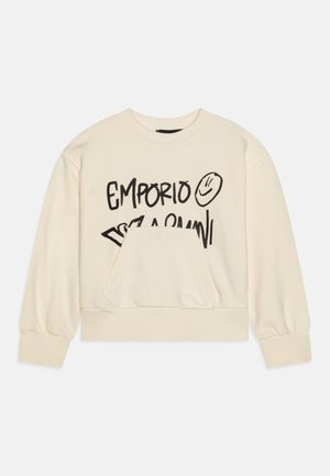 Tejfehér színű pulóver kerek nyakkal, hosszú ujjú, elöl zsebbel. Fekete grafikás szöveggel és mosolygós arc mintával díszítve.