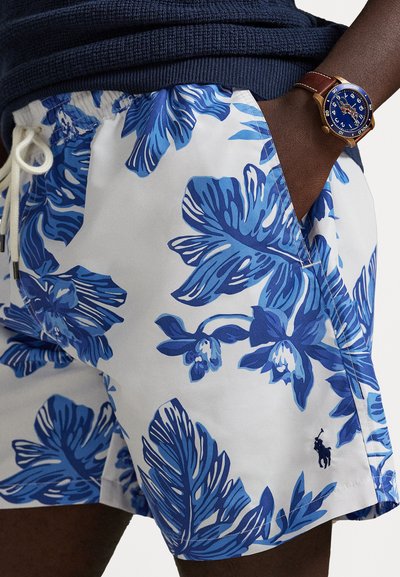 Zilbi un baltas peldbikses ar tropisku ziedu rakstu, kurā ir lielas lapas un ziedi. Elastīga josta ar saitēm, maza logo detaļa.