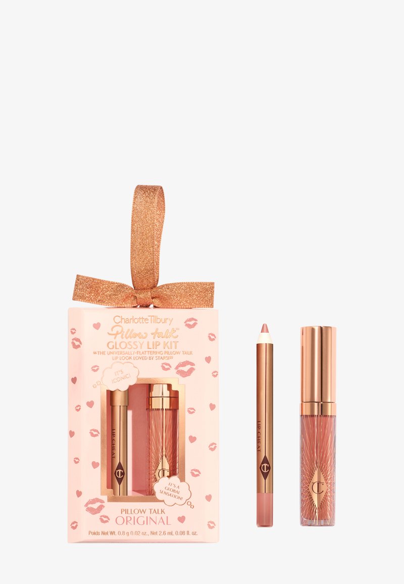 Glossy lip kit in a pink box with a glittery rose gold ribbon. Contains a lip liner, lipstick, and lip gloss in soft nude shades.