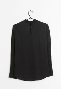 Blusa nera a maniche lunghe con collo alto, apertura a chiave sul retro e pannelli laterali testurizzati. Tessuto morbido con una vestibilità rilassata.