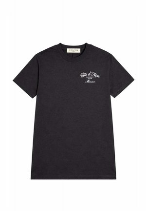 T-shirt noir à manches courtes avec texte blanc « Côte d'Azur Racquet Club Monaco » sur la poitrine gauche et col rond.