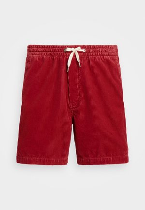 Red corduroy shorts with an elastic waistband and cream drawstring. Vertical ribbed texture and above-the-knee length.