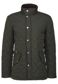 Quilted green jacket with a stand-up collar. Features brass snap buttons and two side pockets. Made from a soft, textured fabric.