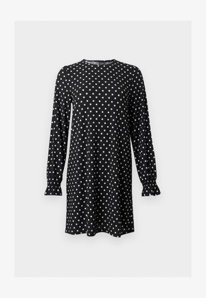 Black long-sleeve dress with white polka dots, round neckline, and gathered cuffs, shown against a plain light background.