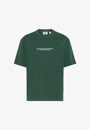 Dunkelgrünes T-Shirt mit kurzen Ärmeln und weißem Text "CORDONSPORT ATHLETICS 1986" zentriert auf der Vorderseite.