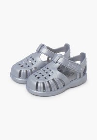 Gray plastic sandals with an open design, featuring crosshatch pattern on the front, adjustable strap, and a textured sole for grip.