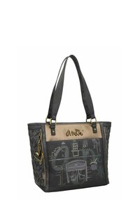 Zwarte en gouden tote bag met ingewikkelde ontwerpen, voorzien van gestructureerde oppervlakken, dubbele schouderbanden en decoratieve hardware accenten.