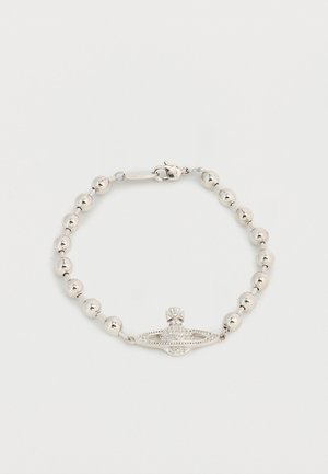 Silver beaded bracelet with a central oval charm featuring a cross and small embedded crystals, clasp closure on a white background.