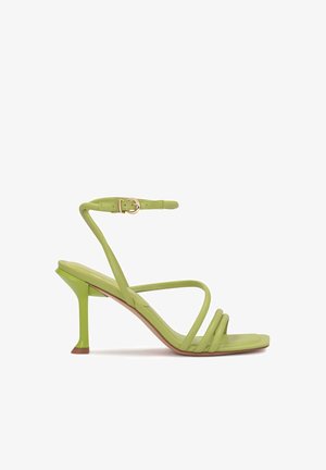 Green strappy heeled sandals with a smooth leather finish, featuring a unique angular heel and a slender ankle strap with a gold buckle.