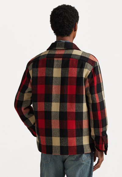 Red, black, and beige checkered flannel shirt with a collared neckline, long sleeves, and a straight hem, featuring a textured fabric pattern.