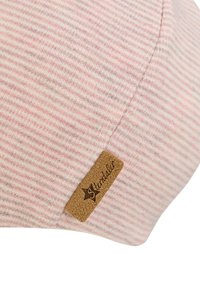 Light pink striped cap made of soft fabric, featuring a textured surface and a brown leather logo tag stitched on the side.