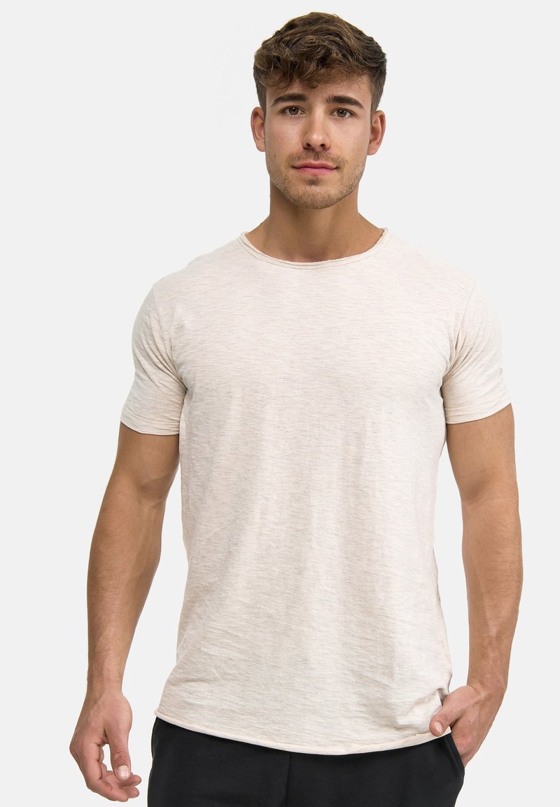 Lichtbeige T-shirt met korte mouwen gemaakt van zachte, textuurstof, met een ronde halslijn en een relaxte pasvorm.