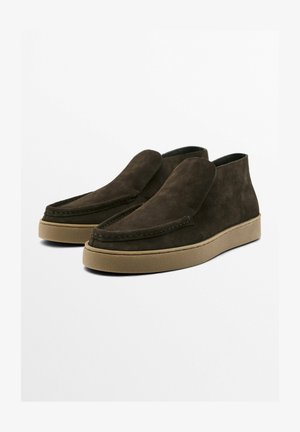 Brown suede ankle boots with a smooth finish, raised stitching and a rubber sole. The design features a rounded toe and slip-on style.