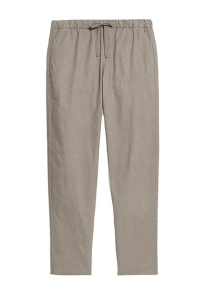 Light brown, relaxed-fit pants made of a soft material with an elastic waistband and front pockets. Tapered leg design.