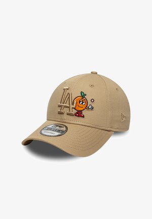 Beige Baseballkappe mit erhöhtem "LA"-Logo und einem bestickten, orangefarbenen Cartoon-Charakter, der rote Schuhe trägt und einen Baseball wirft.