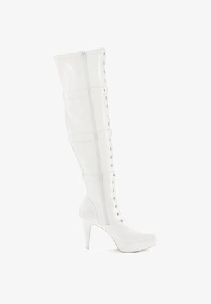 White over-the-knee boots made of glossy patent material, featuring a lace-up front, zipper closure, and a stiletto heel.