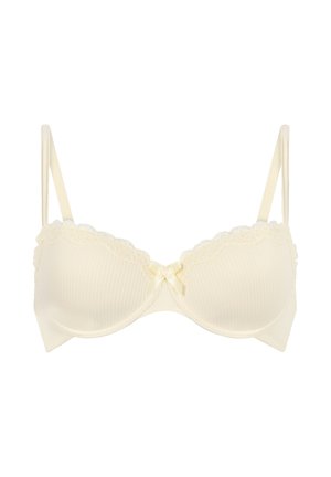 Cremefarbener BH mit geripptem Stoff, Spitzenverzierung entlang der oberen Kante, dünnen verstellbaren Trägern und einer kleinen Satinschleife in der Mitte.