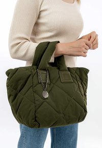 Quilted green tote bag with padded handles, featuring a metal chain accent and label. The fabric appears soft with a shiny finish.