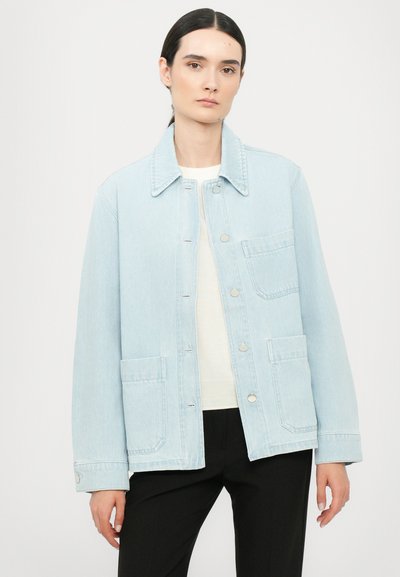 Light blue denim jacket featuring a button-up front, two front pockets, a classic collar, and a relaxed fit with minimal stitching details.