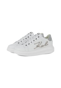 Des baskets blanches avec un dessus en cuir lisse, des accents de paillettes argentées sur le talon et un détail de logo métallique. Elles sont dotées de lacets ronds et d'une semelle en caoutchouc.