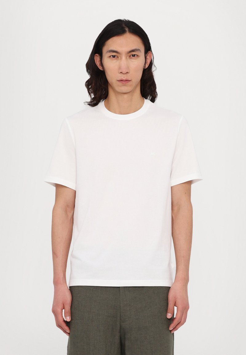 White cotton t-shirt with short sleeves, round neckline, and small logo detail on the chest. Simple and plain design with no patterns.