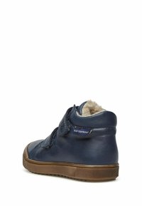 Vattentät hög sko i marinblå läder med en strukturerad yta, kardborreband och en gummisula med en brun accent.