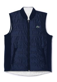 Chaleco sin mangas azul marino con cierre frontal, diseño acolchado, cuello acanalado y bolsillos laterales. Presenta un pequeño logo verde y rojo en el pecho.