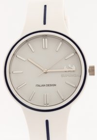 White silicone strap watch with a gray circular dial, silver hour and minute hands, and black accents. "SUPERGA" and "ITALIAN DESIGN" printed on the face.