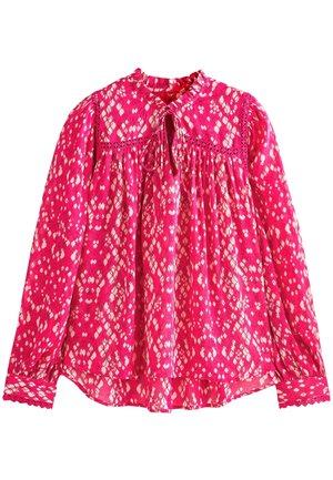 Pink long-sleeve blouse with white diamond pattern, lace trim, a small ruffled collar, and a front tie keyhole neckline.