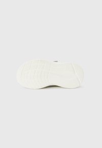 Shoe sole with textured pattern; predominantly white with subtle accents. Slightly curved shape, designed for traction and comfort.