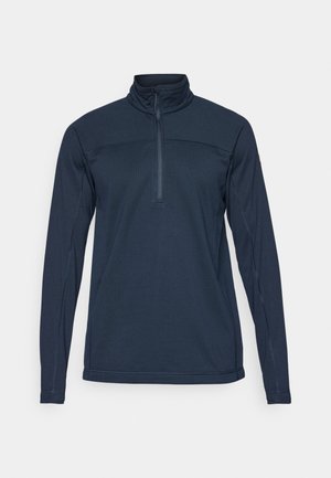 Marineblauwe langetermijnpullover met een hoge kraag en een halve rits aan de voorkant. Beschikt over een gestructureerde stof en contrasterende stikdetails.