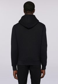 Czarna bluza z kapturem, charakteryzująca się miękką fakturą, ściągaczami na rękawach oraz prostym dołem. Widok z tyłu ukazuje prosty, minimalistyczny design.