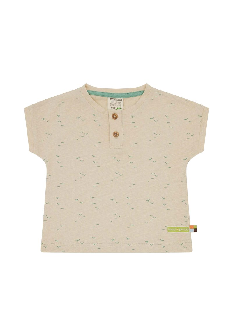 Short-sleeved cream shirt with green bird prints, wooden buttons at the neck, and a green woven label on the hem. Soft fabric texture.