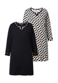 Twee tunieken: één effen zwart met een V-hals en driekwart mouwen; de tweede heeft een witte achtergrond met grote zwarte stippen.