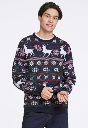 Pull en tricot bleu marine avec des motifs de rennes et de flocons de neige blancs, doté de poignets et d'un ourlet côtelés, dans un design festive de Fair Isle.